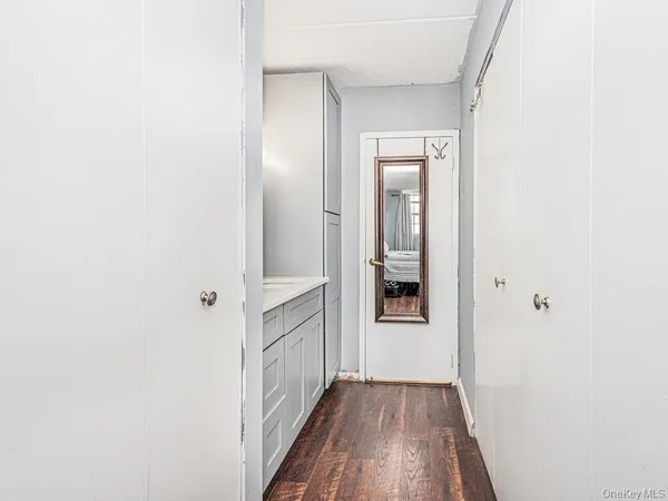 a view of a hallway with wooden floor