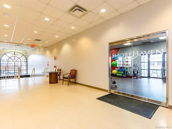 a gym room with lots of furniture and garden view