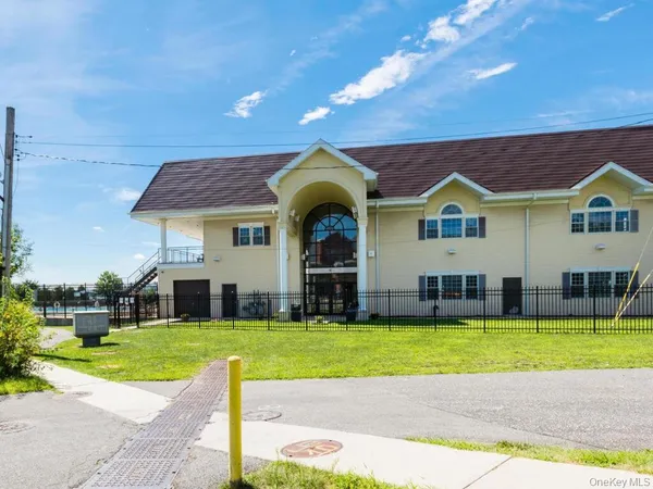 a view of a house with swimming pool and a yard