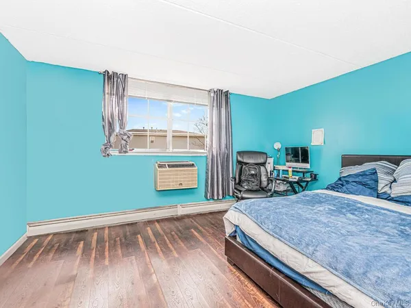 a room with a bed and a bookshelf