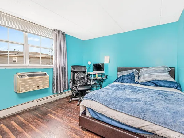 a bedroom with a bed window and dresser