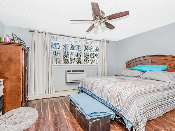 a bedroom with a bed a window and a chandelier