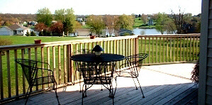 942 Lake Summerset Road Lake Summerset, IL 61019 - Photo 4 of 6 a view of a balcony with wooden floor and outdoor seating