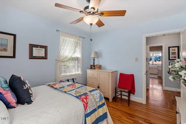 a bedroom that has a bed and a table in it