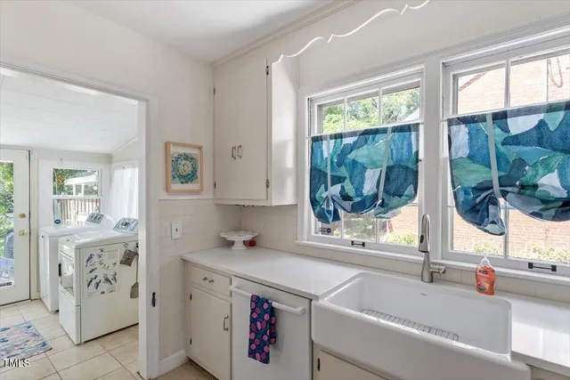 a bathroom with a tub sink and large window