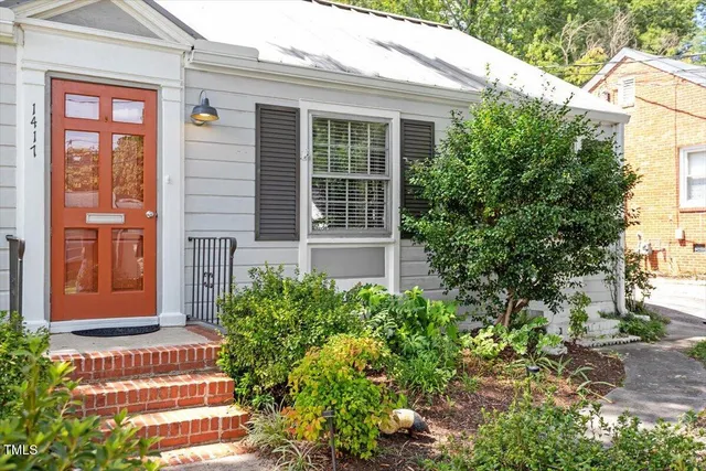 a front view of a house with a garden