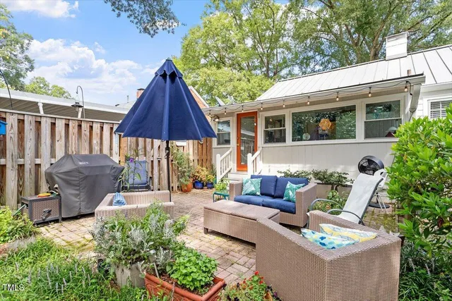 a view of a patio with couches chairs and a potted plant