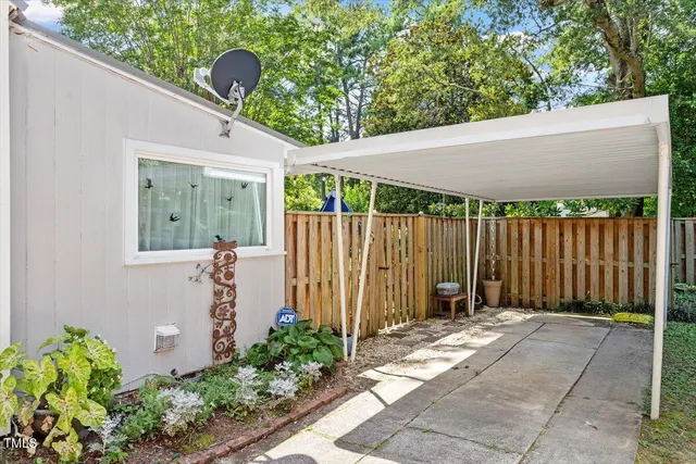 a backyard of a house with plants and outdoor seating