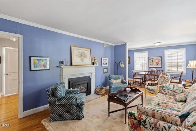 a living room with furniture fireplace and window