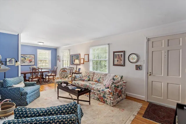 a living room with furniture a rug and a window