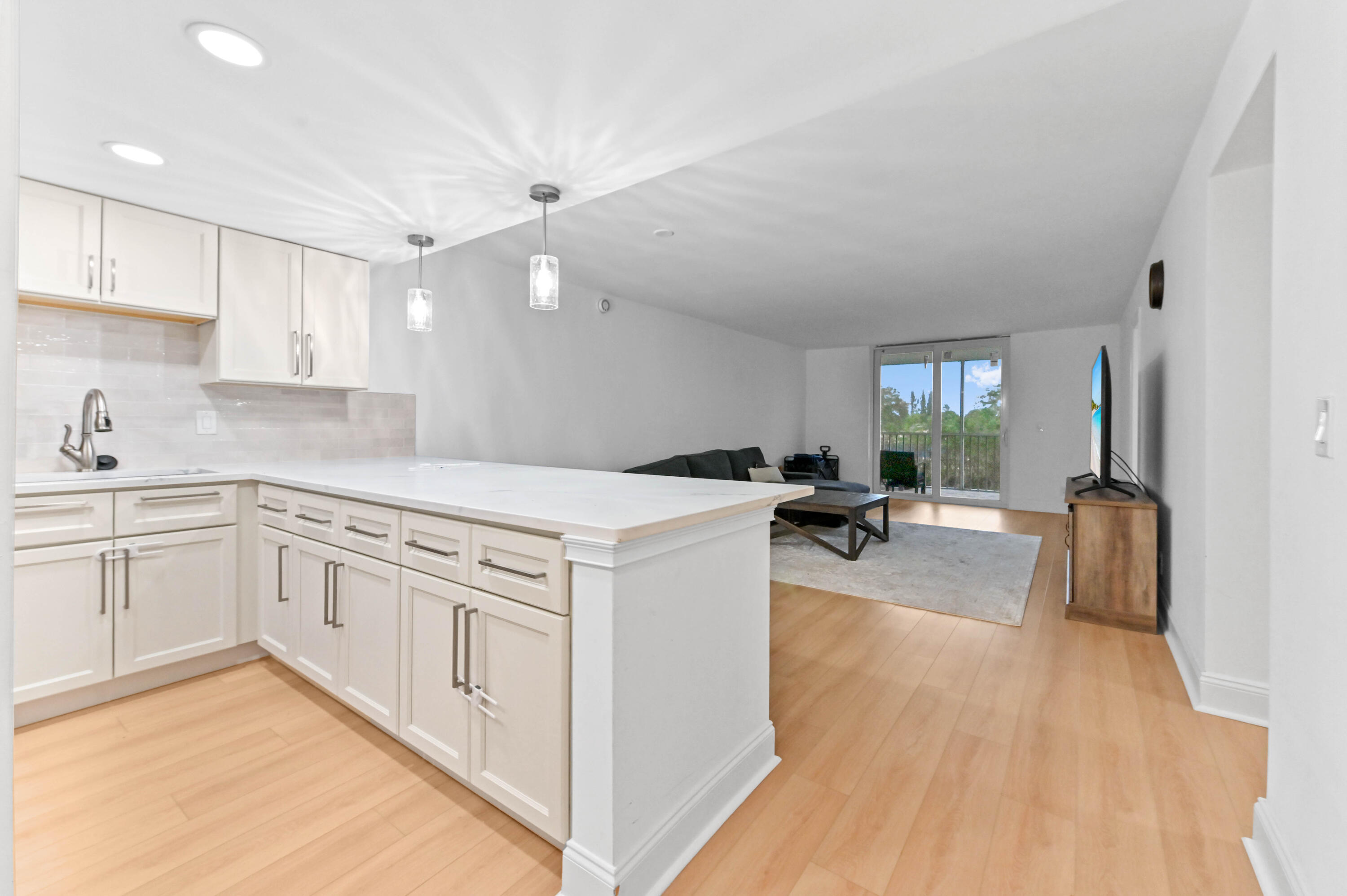 5700 Northwest 2nd Avenue, Unit 211 Boca Raton, FL 33487 - Photo 4 of 29 a kitchen with white cabinets and sink