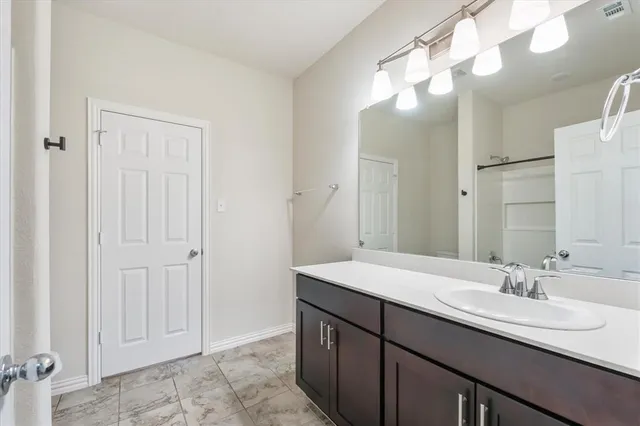 a bathroom with a sink a vanity and a mirror