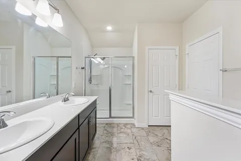 a bathroom with a double vanity sink mirror and double