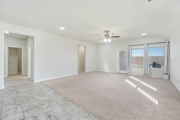 a view of an empty room with a chandelier