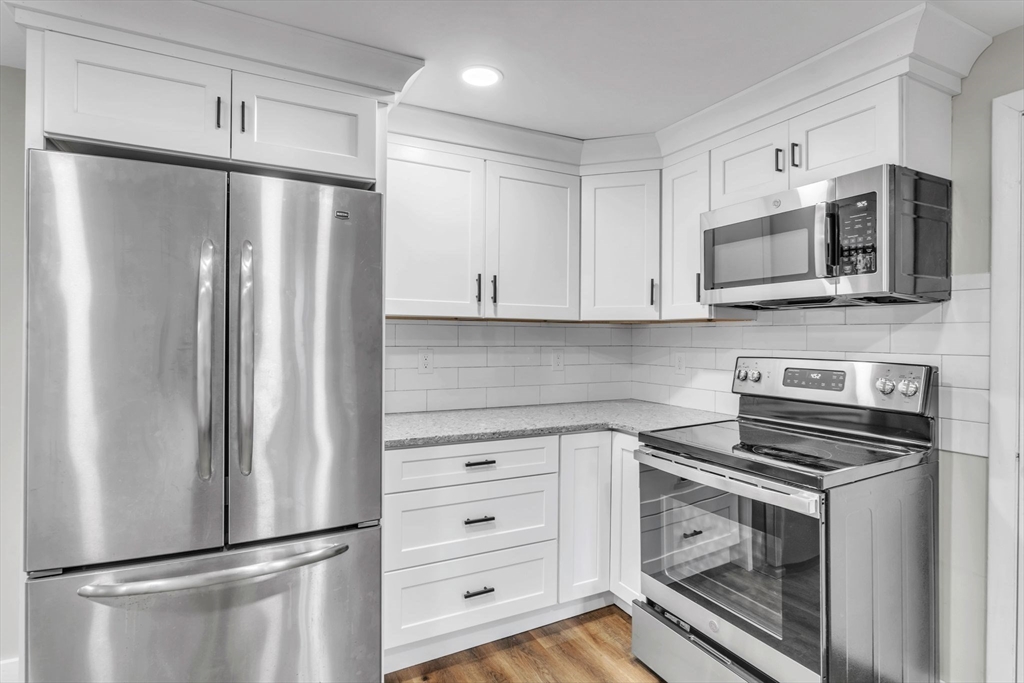 140 Greenwich Plains Road Ware, MA 01082 - Photo 13 of 42 a kitchen with stainless steel appliances white cabinets and a refrigerator