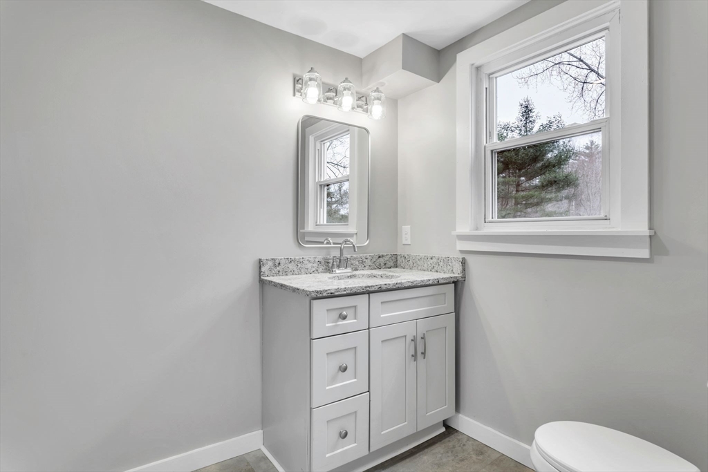 140 Greenwich Plains Road Ware, MA 01082 - Photo 18 of 42 a bathroom with a granite countertop toilet sink and mirror
