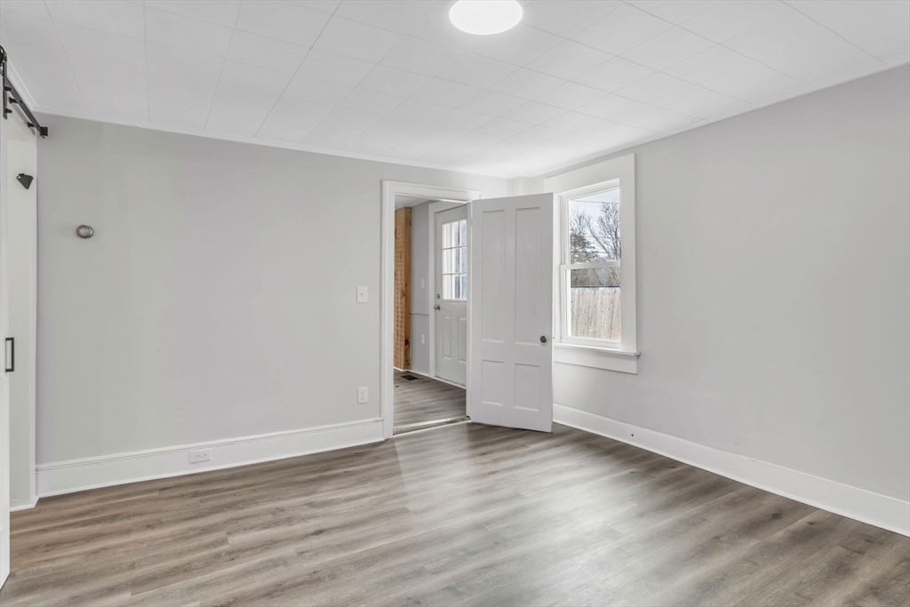 140 Greenwich Plains Road Ware, MA 01082 - Photo 24 of 42 a view of an empty room with wooden floor and a window