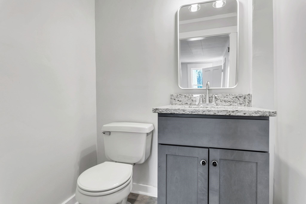 140 Greenwich Plains Road Ware, MA 01082 - Photo 25 of 42 a bathroom with a toilet sink vanity and mirror