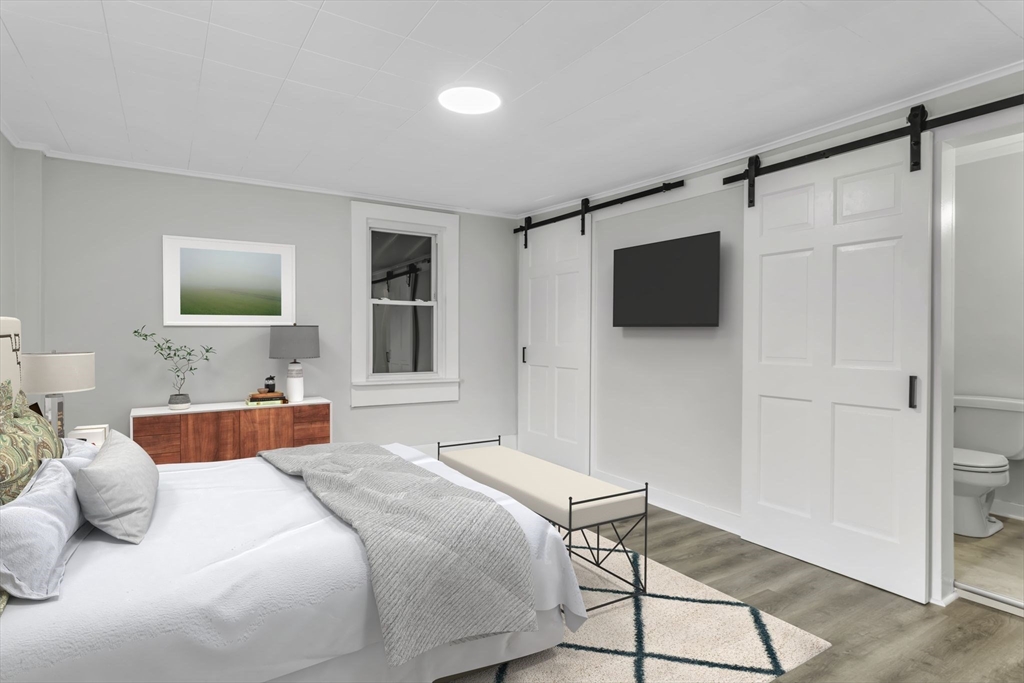 140 Greenwich Plains Road Ware, MA 01082 - Photo 7 of 42 a bedroom with a bed and a flat screen tv