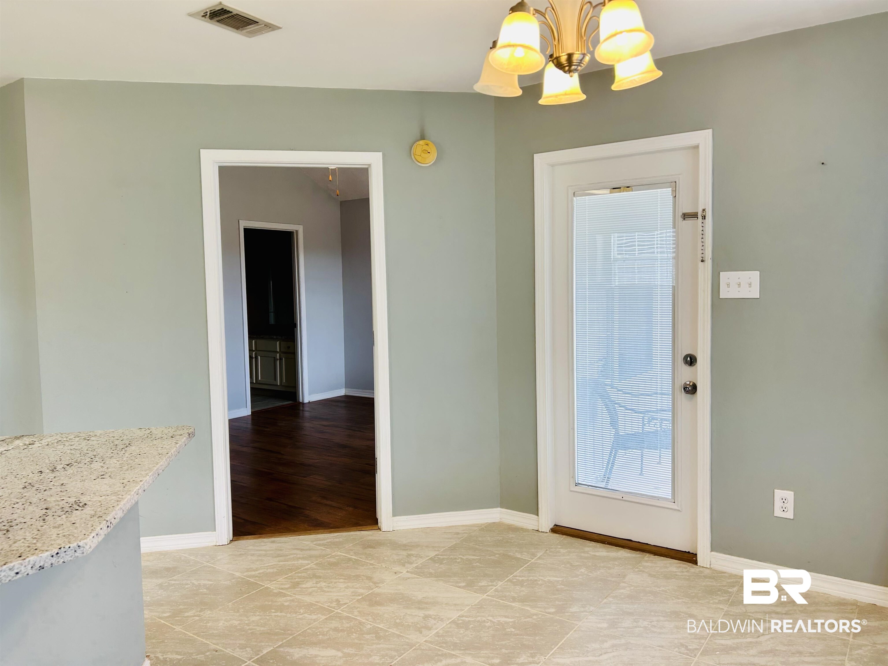 919 Parliament Court Mobile, AL 36695 - Photo 3 of 19 Interior space featuring light tile patterned flooring and a chandelier