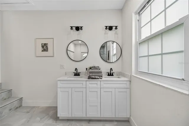 a bathroom with a sink a toilet and a mirror
