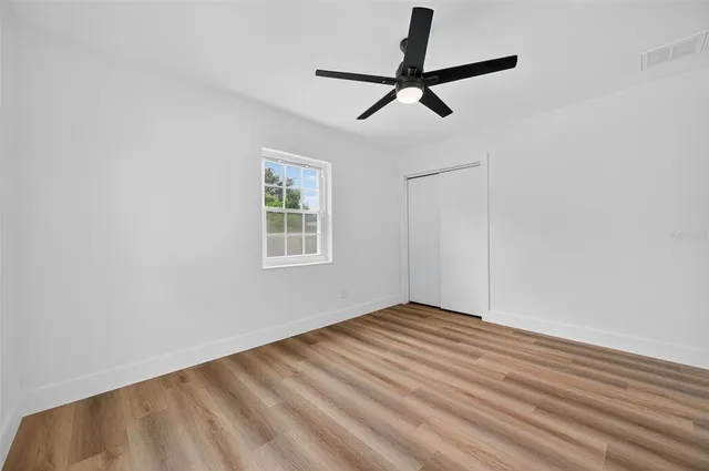 a view of a patio with table and chairs potted plants with wooden fence