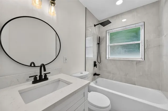 a view of a house with backyard sitting area and garden