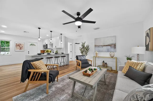 a living room with furniture and a chandelier