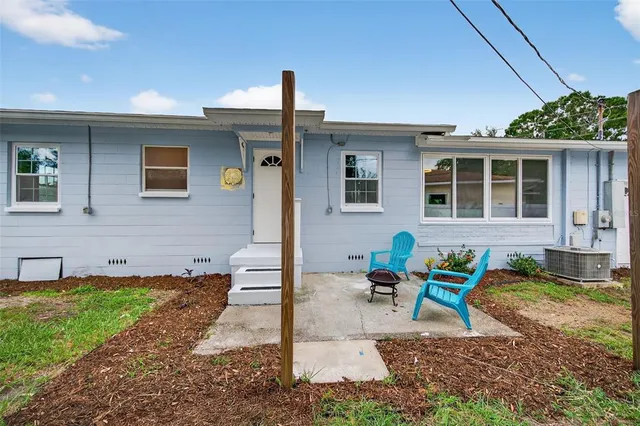 an aerial view of residential houses with outdoor space and swimming pool