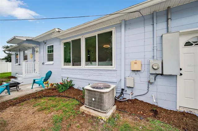 an aerial view of residential houses with outdoor space and trees