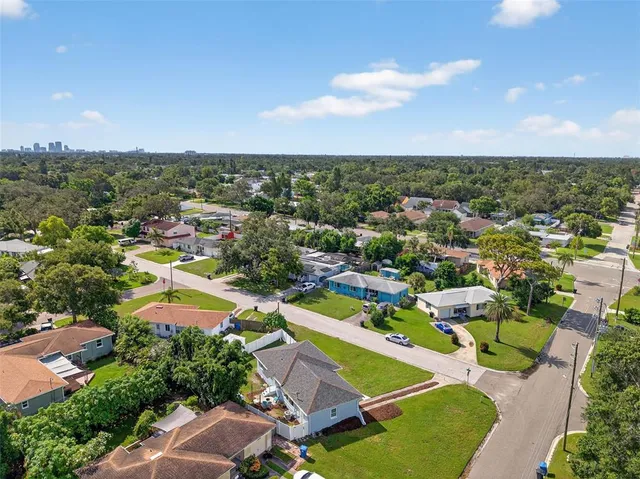 an aerial view of residential houses with outdoor space and street view