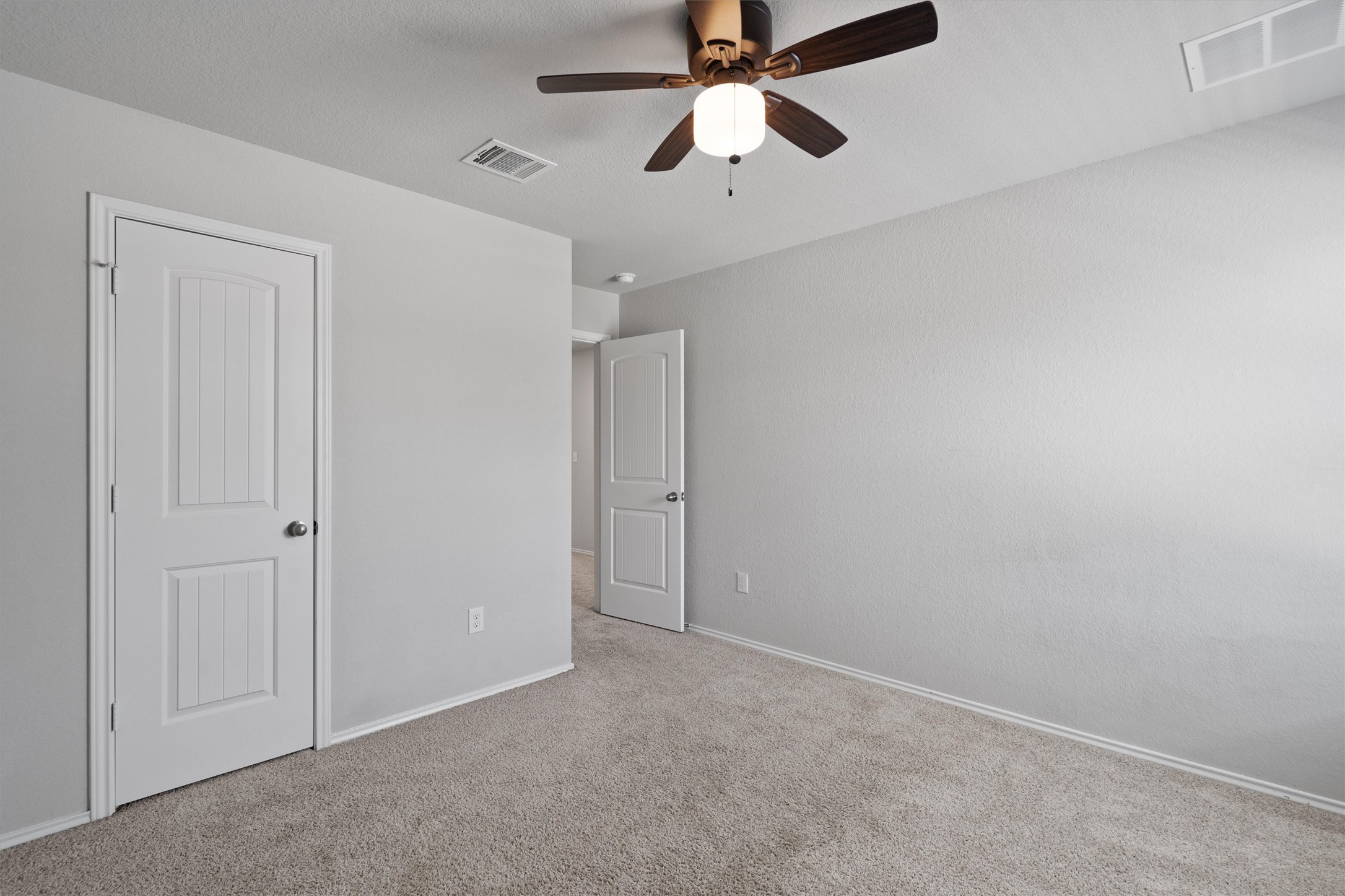 6121 Ronee Leah Drive Austin, TX 78724 - Photo 24 of 30 A well-proportioned bedroom offers comfort with plush carpeting and a modern ceiling fan.