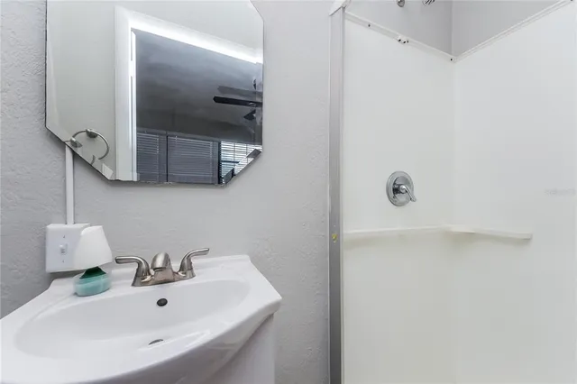 a bathroom with a sink and mirror