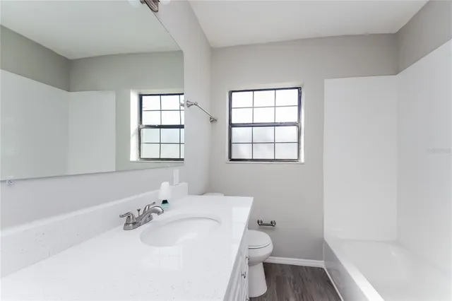 a bathroom with a sink toilet and tub