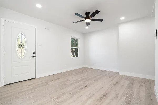 wooden floor in an empty room with a window