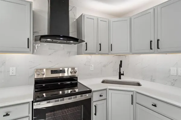 a kitchen with stainless steel appliances a stove and cabinets