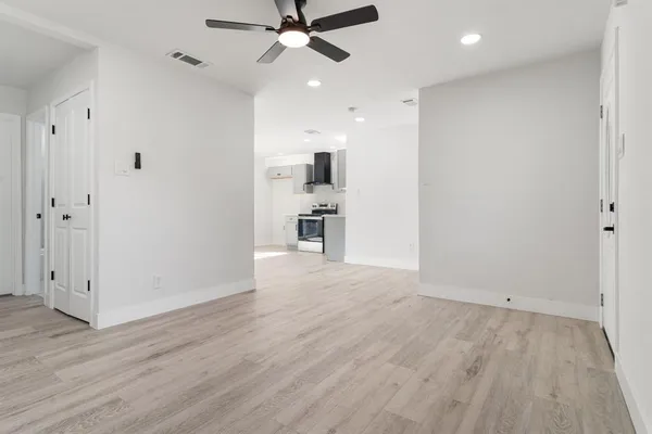 wooden floor in an empty room with a window
