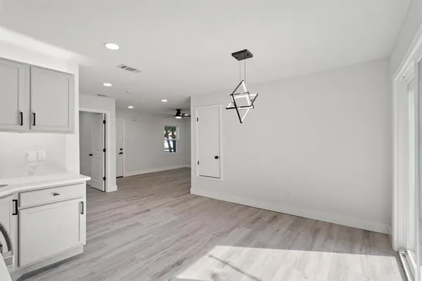 a workspace with wooden floor and windows