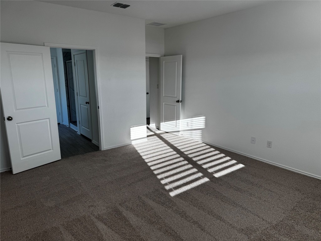 515 Avre Loop Kyle, TX 78640 - Photo 3 of 4 a view of a bedroom with wooden floor
