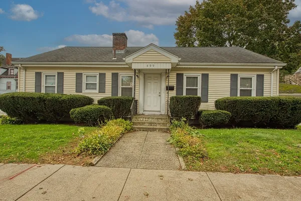 a front view of a house with garden