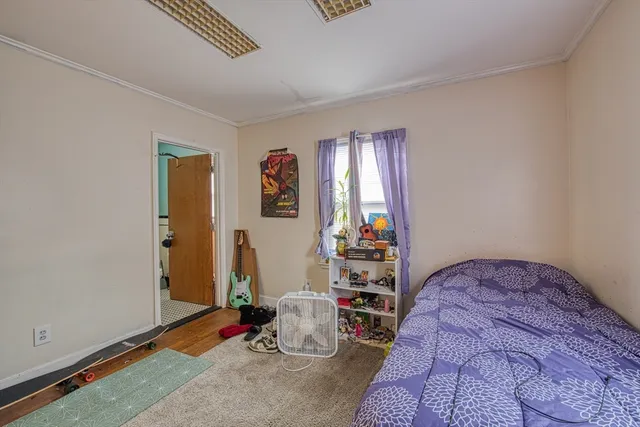 a bedroom with bed and a window