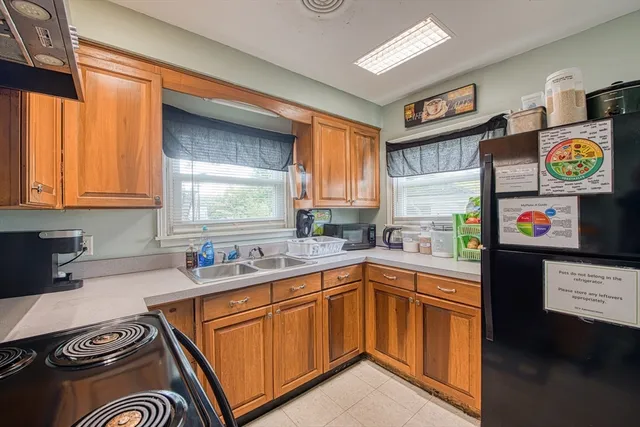 a kitchen with a sink and a stove top oven