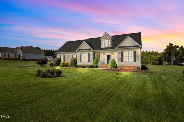 a front view of a house with a garden and plants