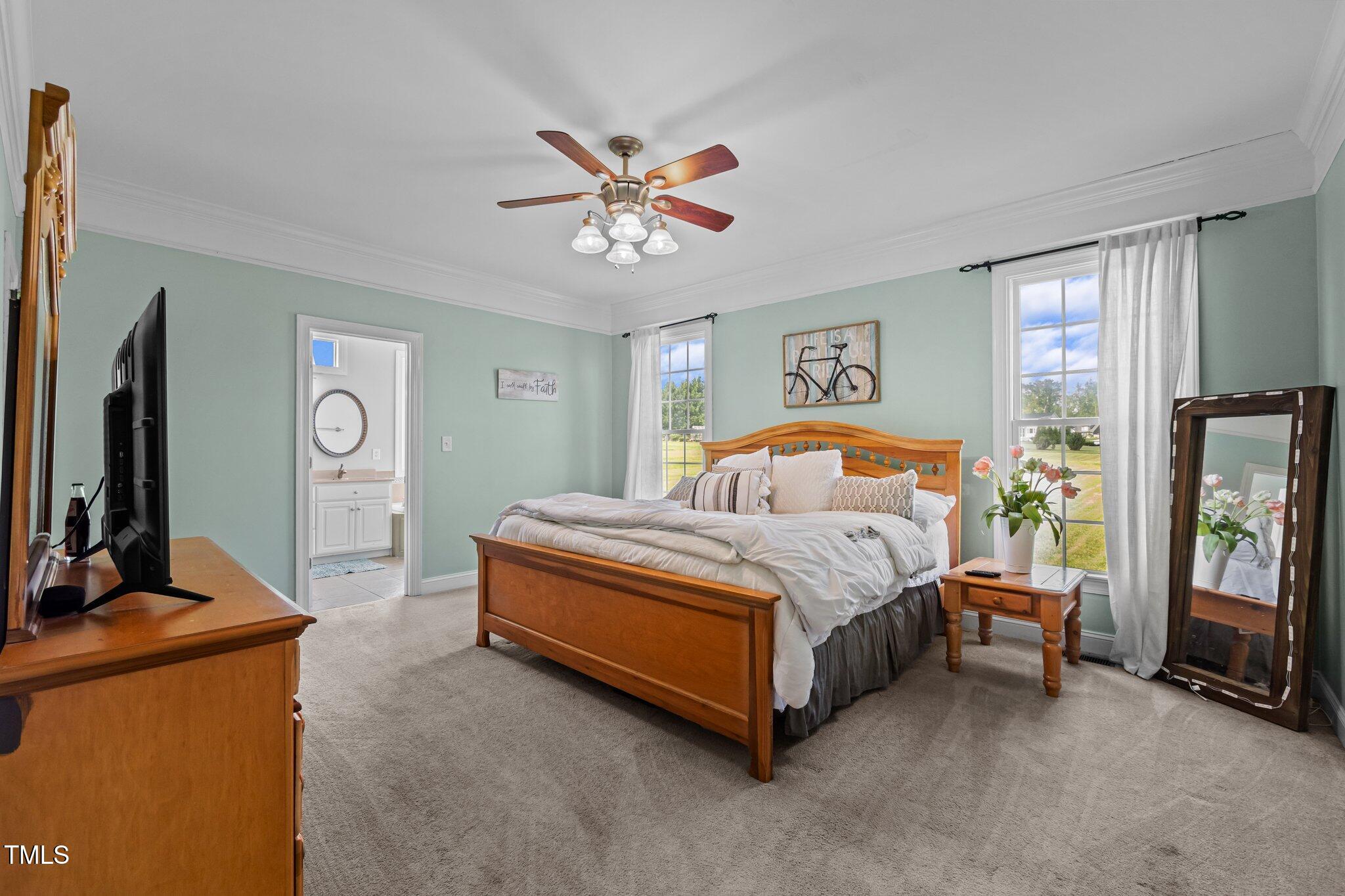 281 Derwin Drive Timberlake, NC 27583 - Photo 13 of 29 a bedroom with a bed a dresser and flat screen tv
