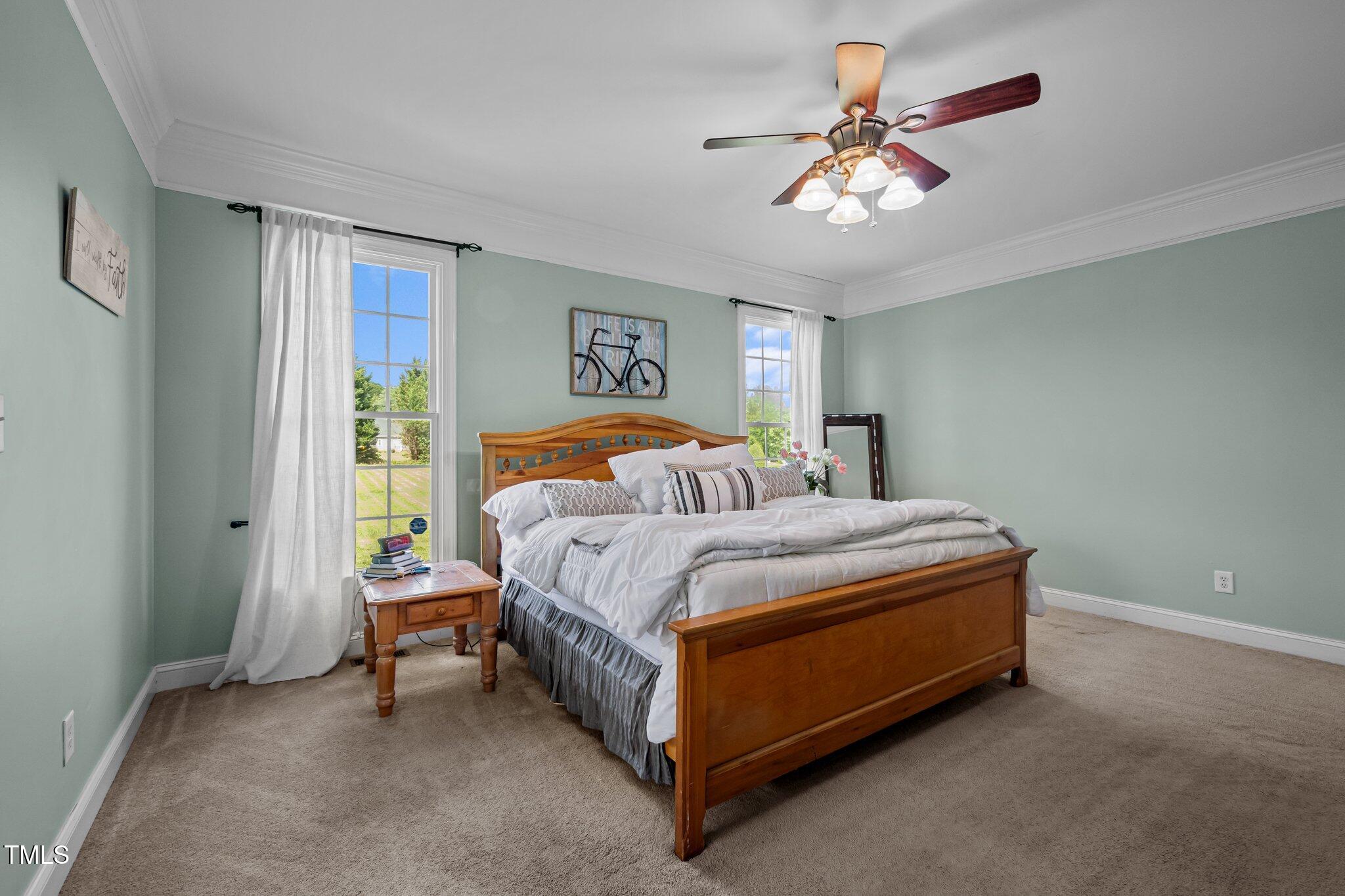 281 Derwin Drive Timberlake, NC 27583 - Photo 14 of 29 a bedroom with a bed and a chandelier