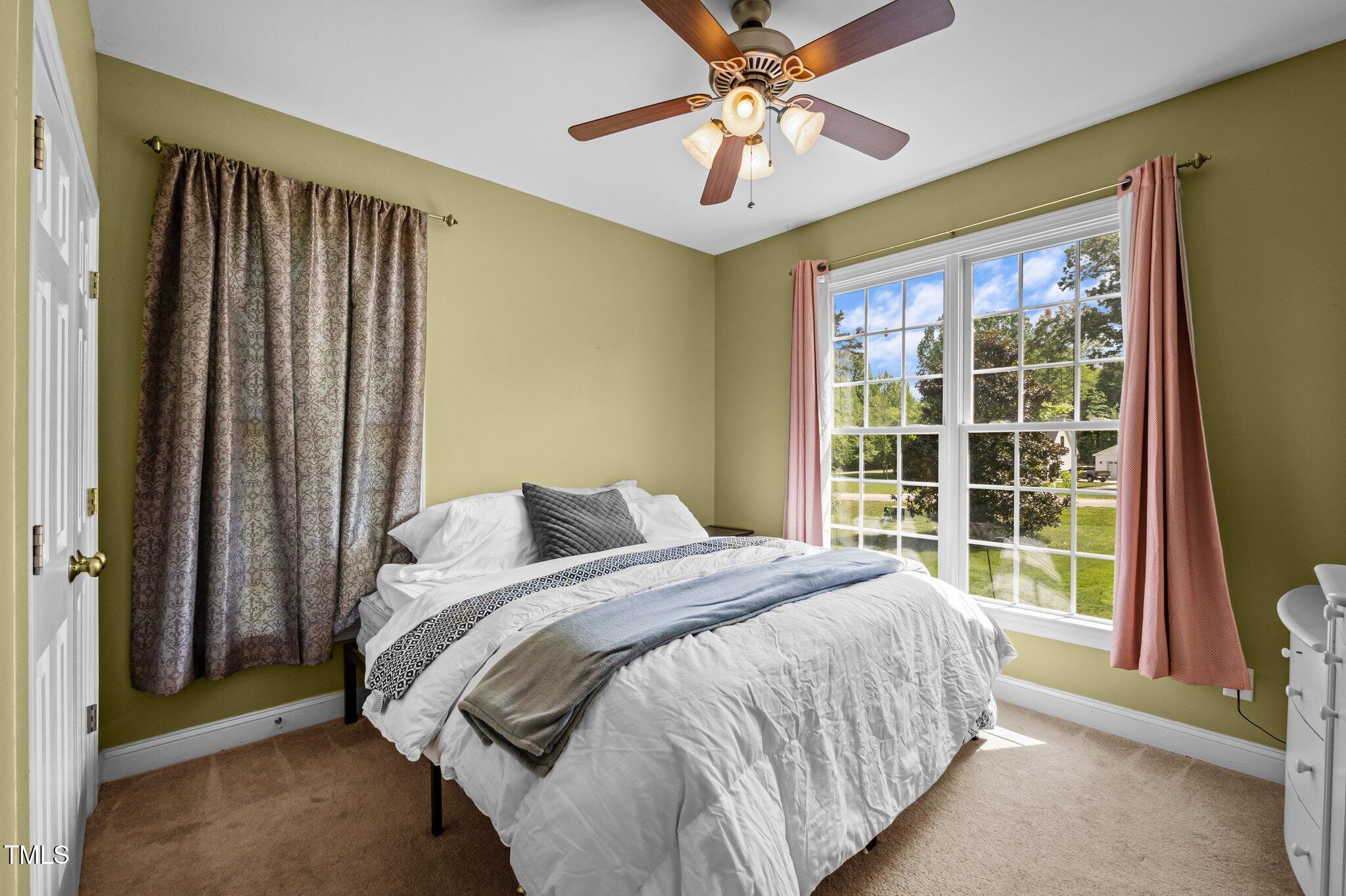281 Derwin Drive Timberlake, NC 27583 - Photo 17 of 29 a bedroom with a large bed and a large window