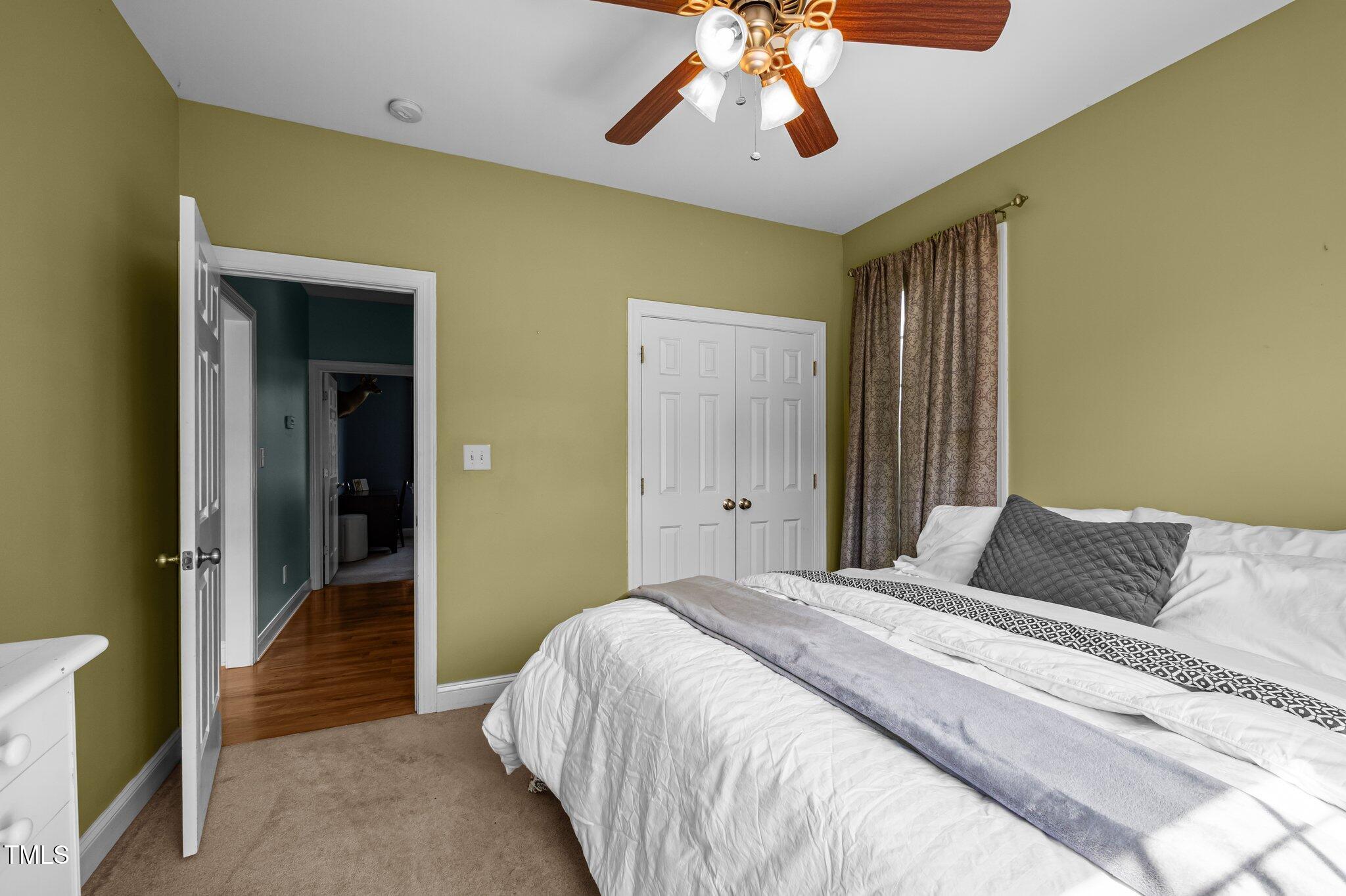 281 Derwin Drive Timberlake, NC 27583 - Photo 18 of 29 a bedroom with a large bed and a chandelier