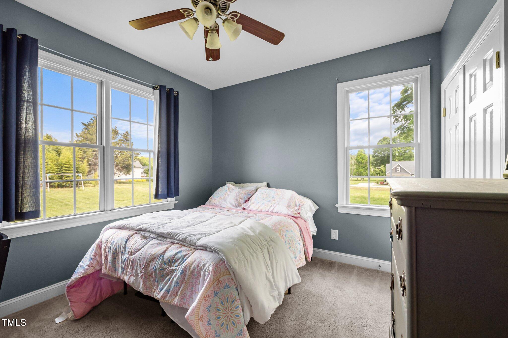 281 Derwin Drive Timberlake, NC 27583 - Photo 20 of 29 a bedroom with a bed and a large window