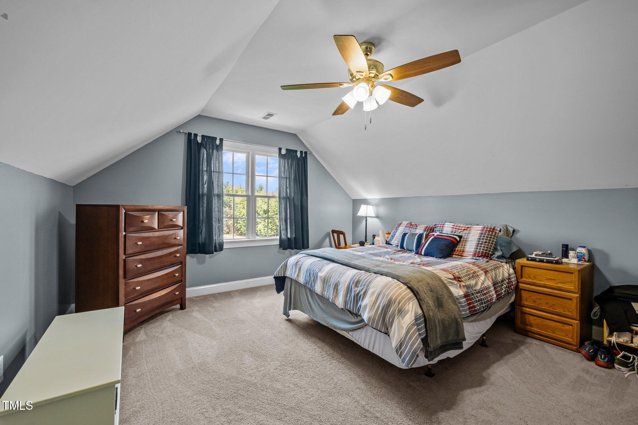 281 Derwin Drive Timberlake, NC 27583 - Photo 24 of 29 a bedroom with a bed and a chandelier