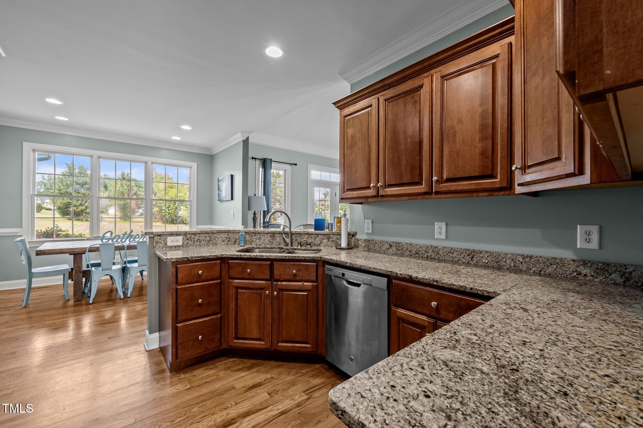 281 Derwin Drive Timberlake, NC 27583 - Photo 8 of 29 a kitchen with a sink and wooden cabinets
